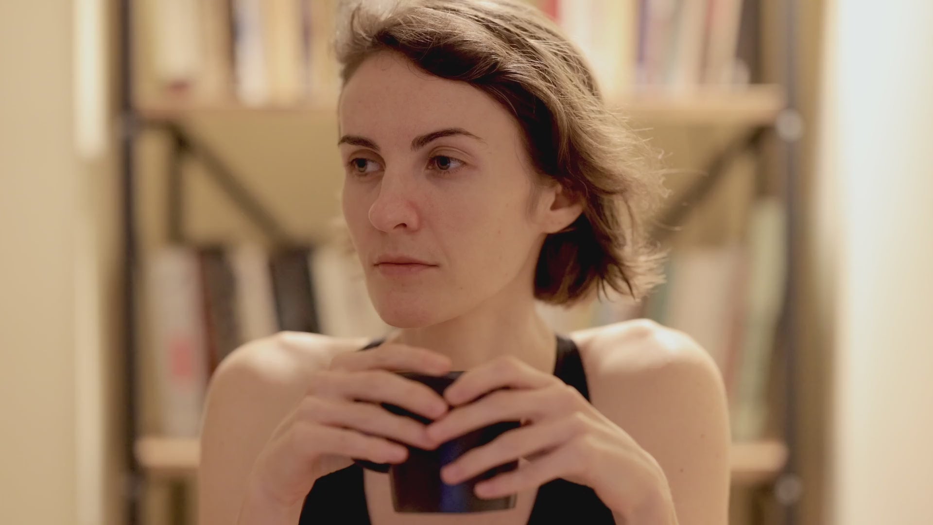 Woman having coffee with air conditioning blowing