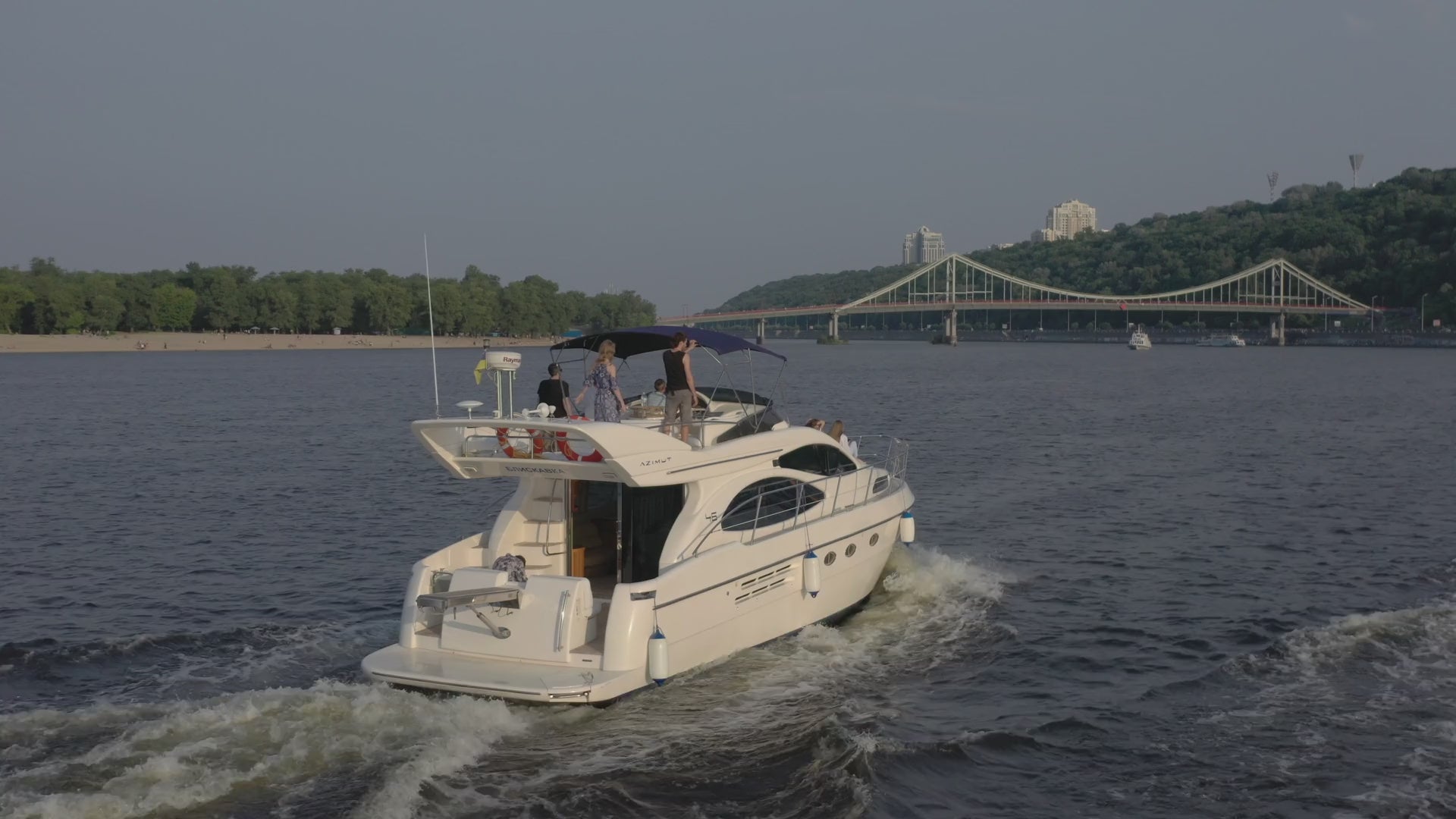 luxury yacht sailing with people on the top deck